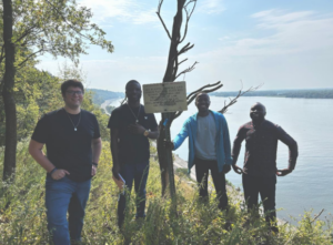 Four males with river as backdrop