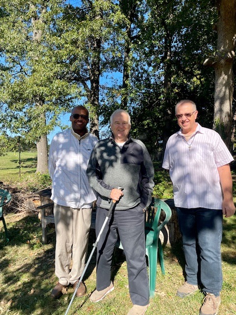 Three males, one with a cane