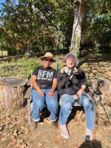 Woman and man sitting under tree