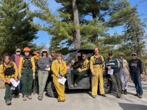 Crew dressed in yellow standing in the woods