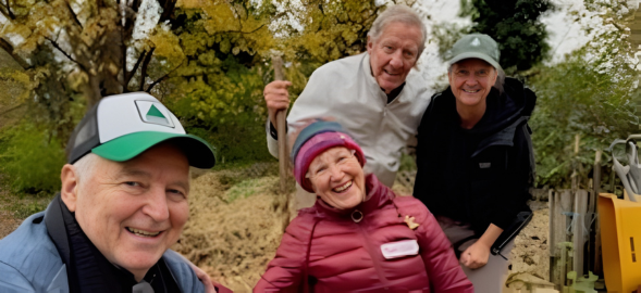 Four people males and females, 2 sitting and 2 standing