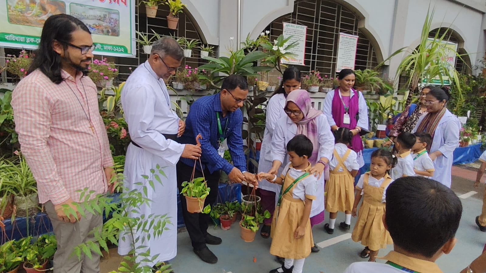 People handing out plants to students